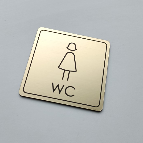 zlatý piktogram WC ženy